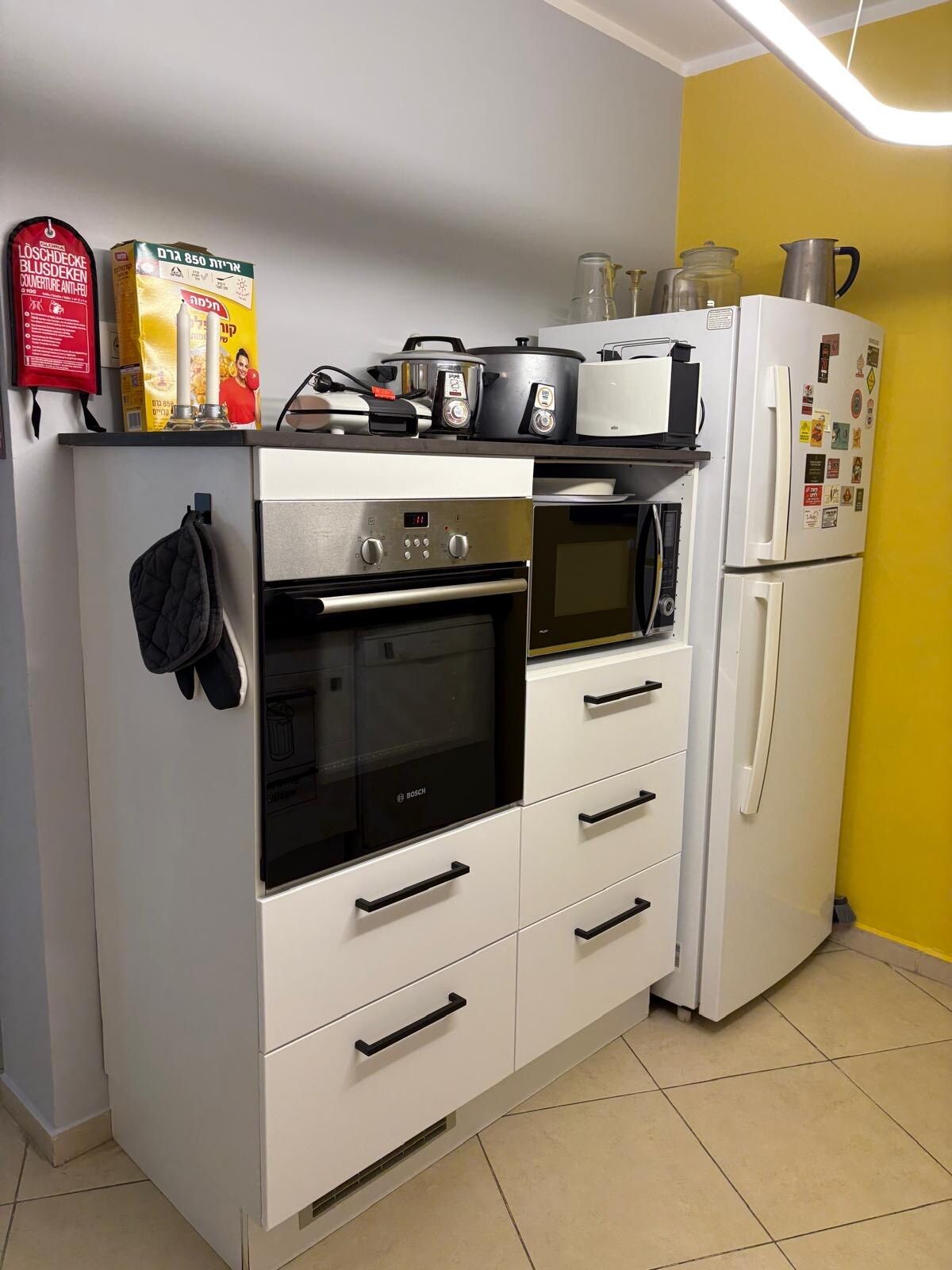Well-kept kitchen with built-in oven, microwave and refrigerator