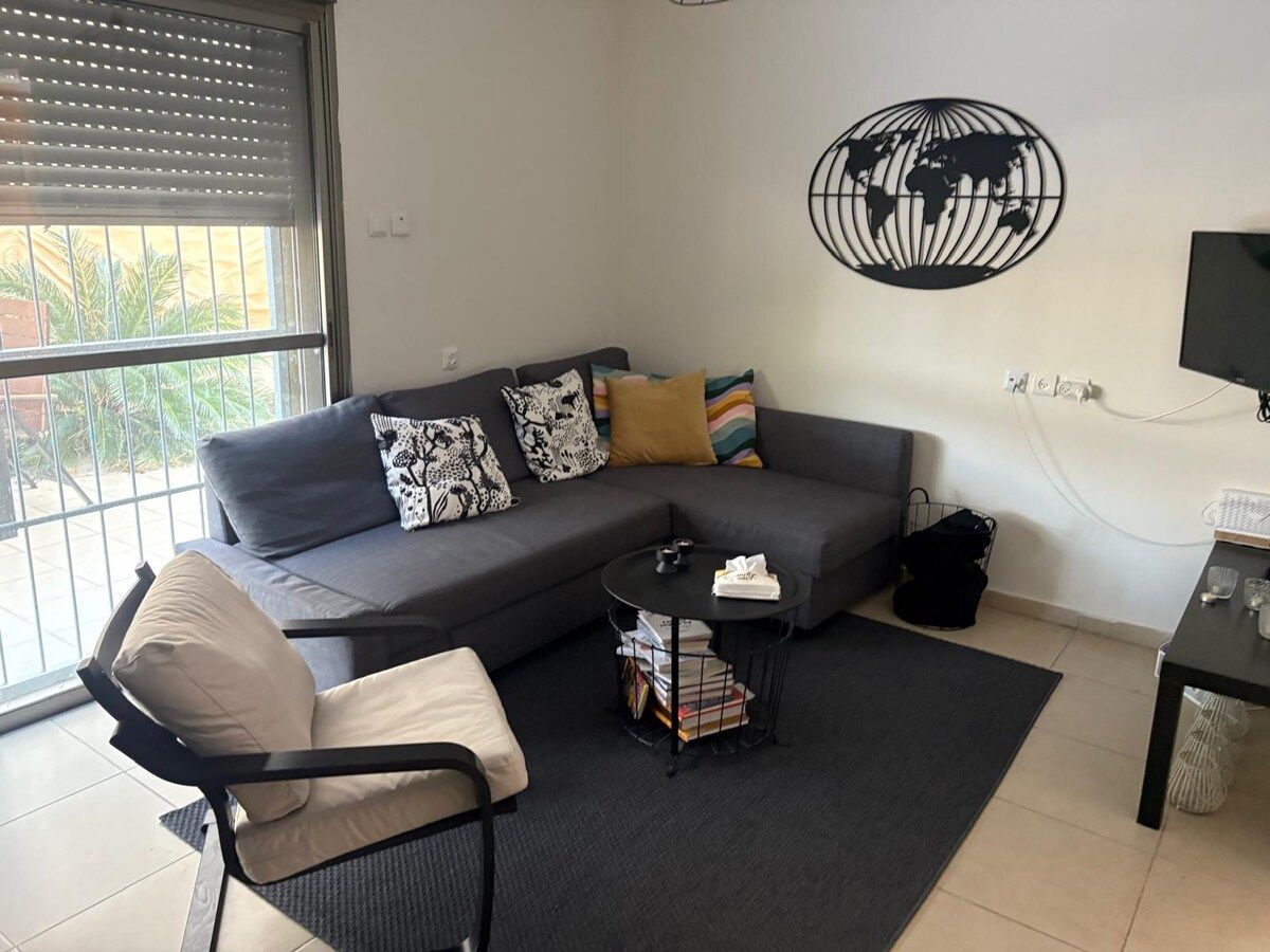 Bright living room with a grey sofa, ready for guests